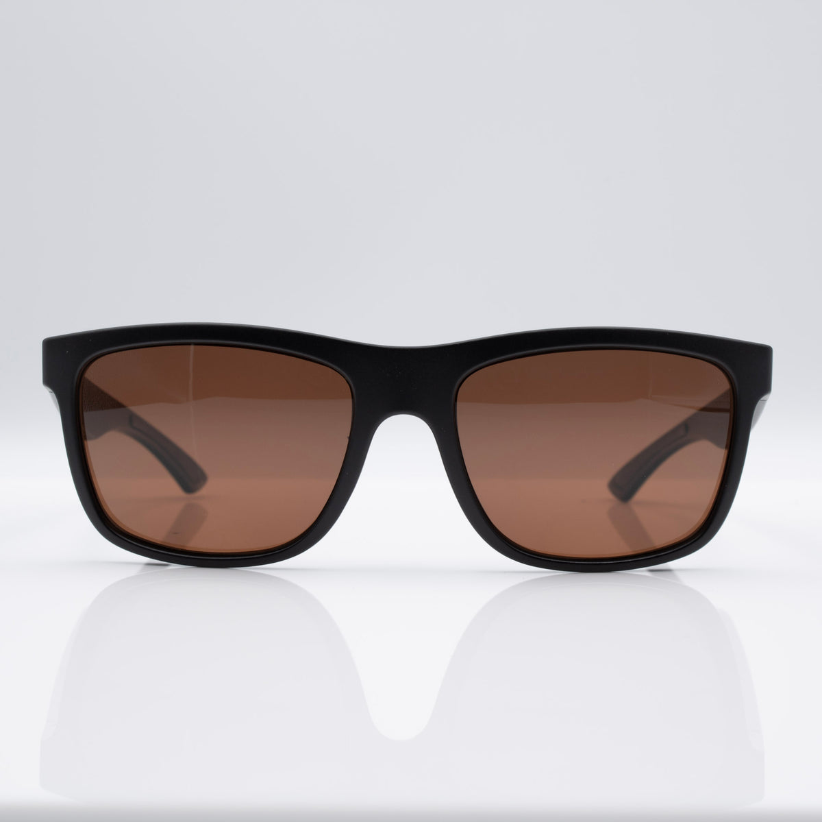 Matte Stealth Black Inverted sunglasses with bronze lenses, angled profile showing lightweight performance frame.