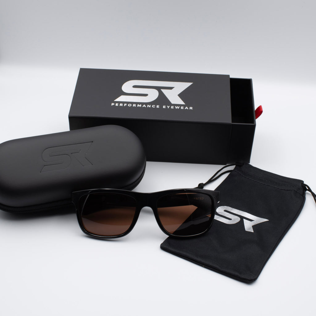 Stealth Gloss Black Inverted sunglasses with bronze lenses and premium SR Performance Eyewear packaging.