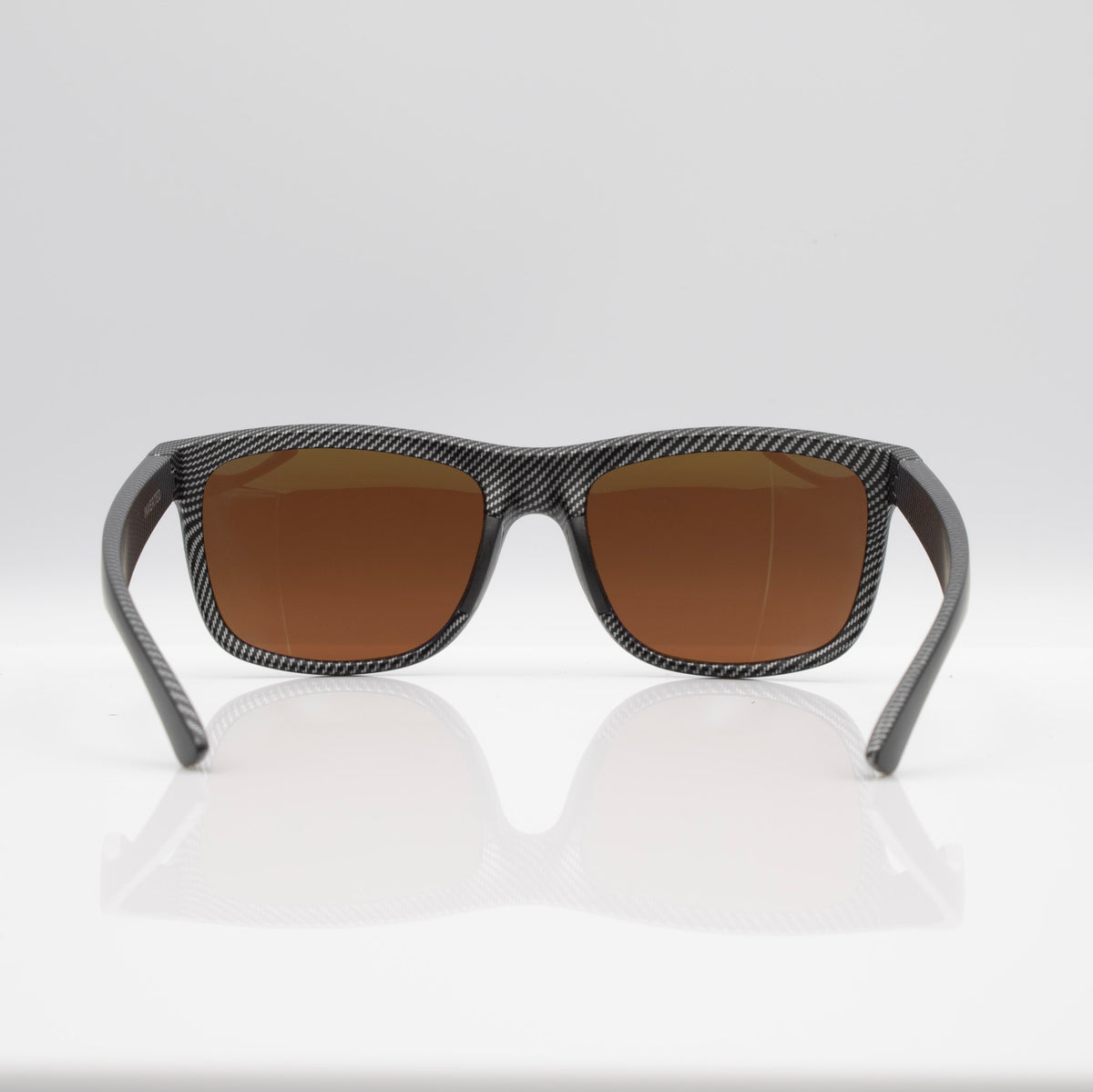 Inverted Blackout Edition sunglasses in Matte Black Carbon with bronze CEVART polycarbonate lenses, clean front view.