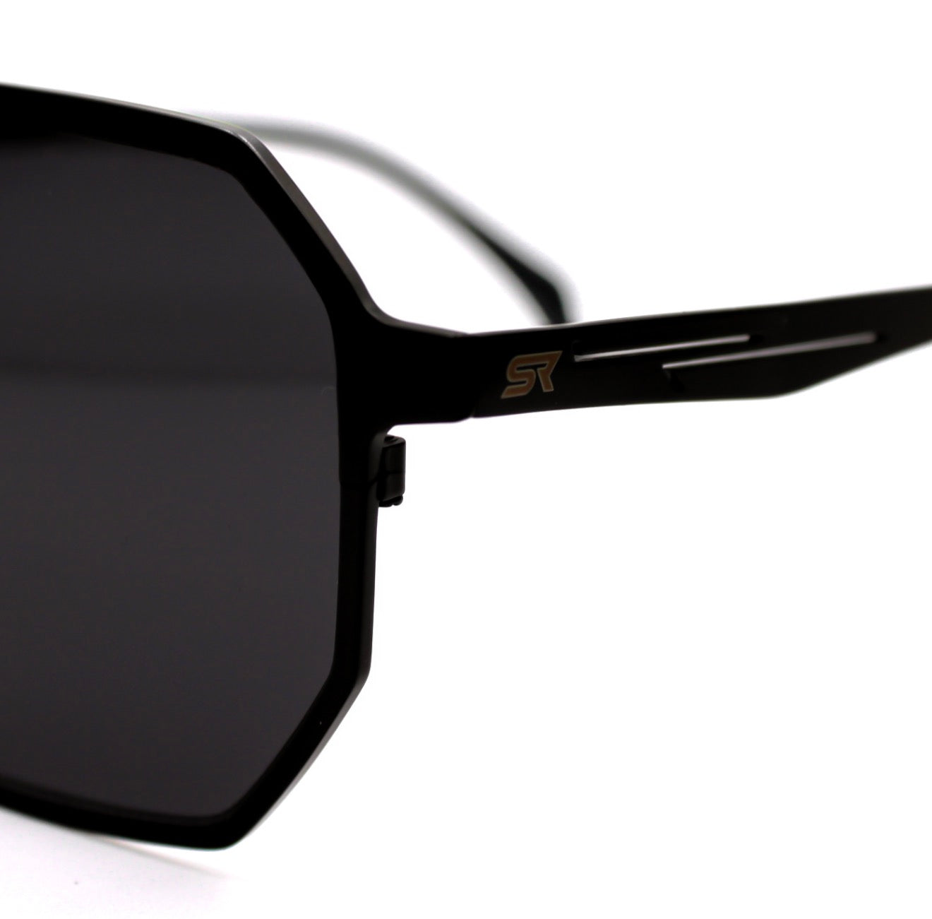 Close-up of SR Performance Eyewear Vector sunglasses showing pure titanium black frame and engraved SR logo