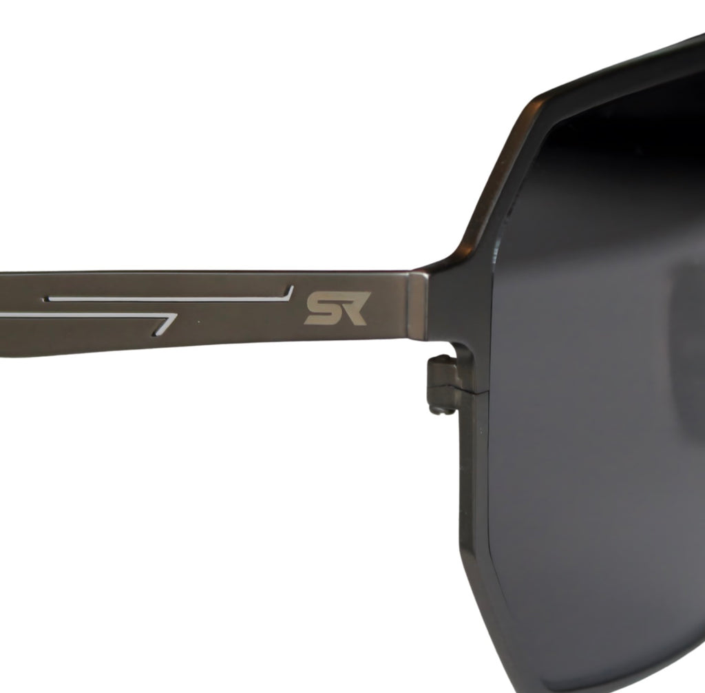 Close-up of SR Performance Eyewear Vector sunglasses showing pure titanium gunmetal frame and engraved SR logo