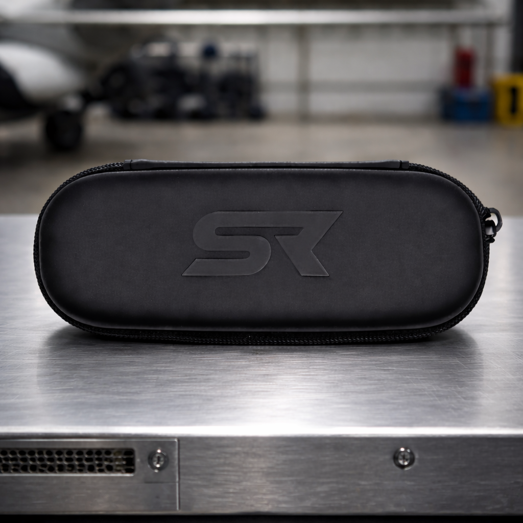 SR Performance Eyewear SR protective sunglasses case with embossed logo sitting on metal table in hangar.