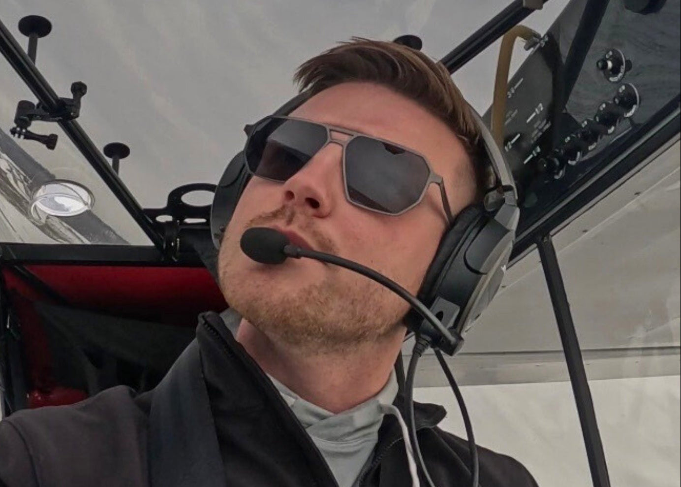 Pilot wearing SR Performance Eyewear sunglasses while scanning instruments and airspace in flight
